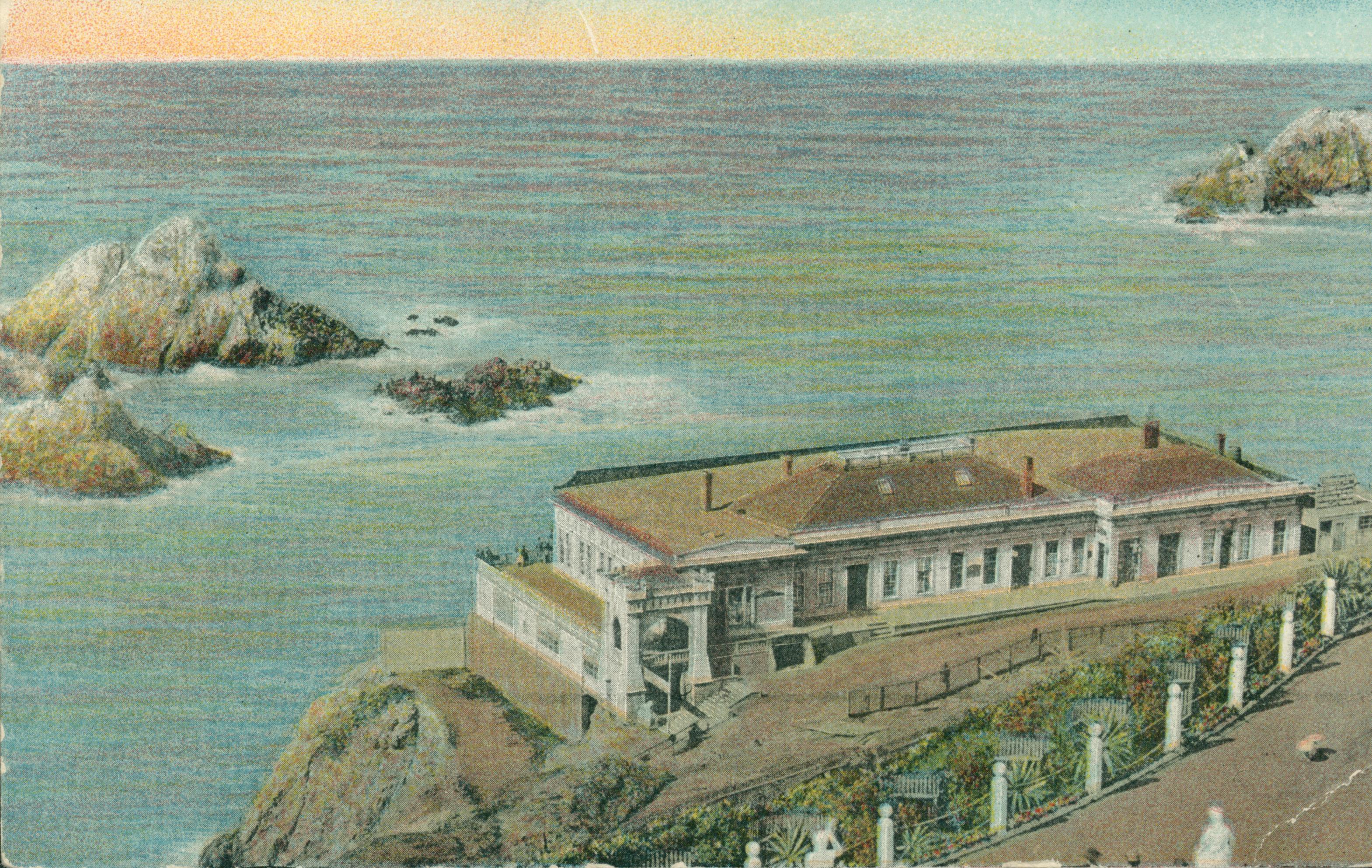 Shows the Cliff House and Seal Rocks, with the statues on Sutro Heights in the foreground.